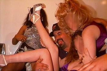 Howard in Dollies Playhouse restroom cavorting with topless dancers