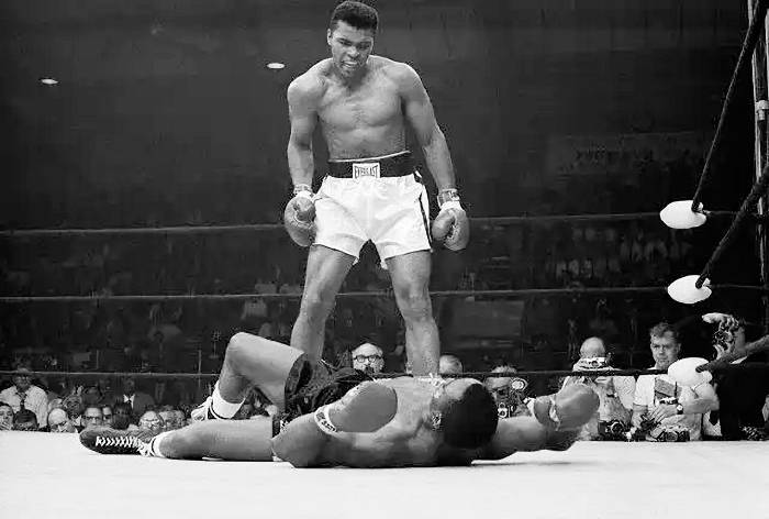 picture:  all time greatest boxer who ever lived Muhammad Ali towering over Sonny Listeon