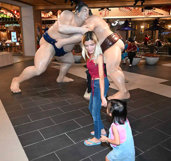 Beware of the Monkey:  picture of statue of sumo wrester with Mali and her 3 year old