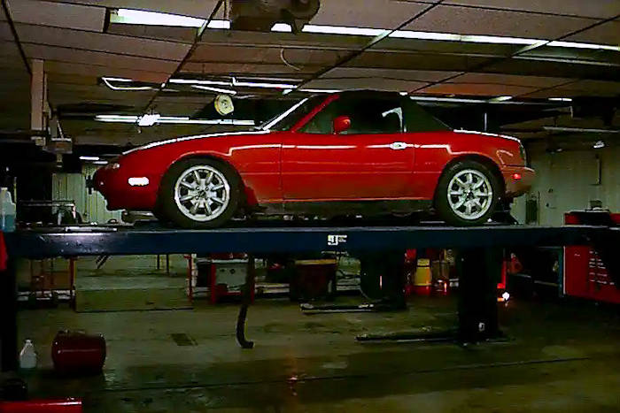 picture:  supercharged Mazda Miata sportscar having larger wheels installed