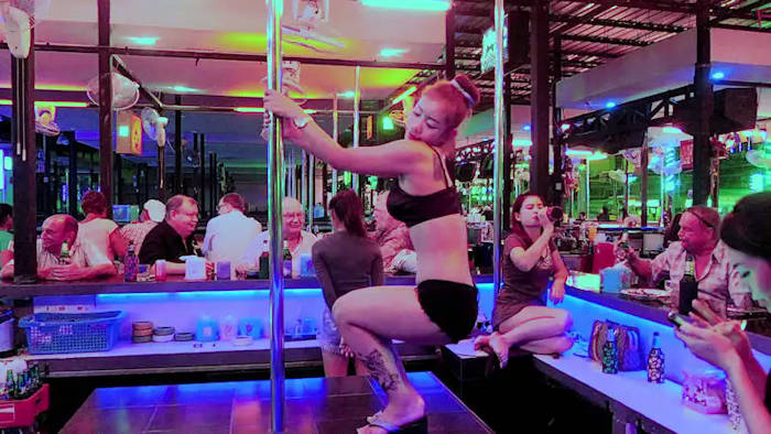 picture:  Bar girl on stage puts on some suggestive moves