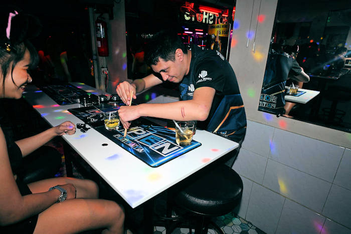 Thomas showing his bar girls how to play Chopsticks Jack Style
